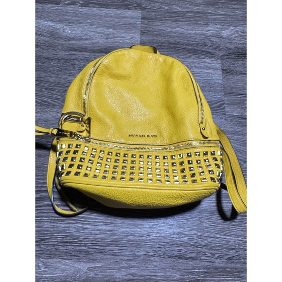 Michael Kors Handbags - Michael Kors Yellow Gold Studded Leather Rhea Medium Backpack